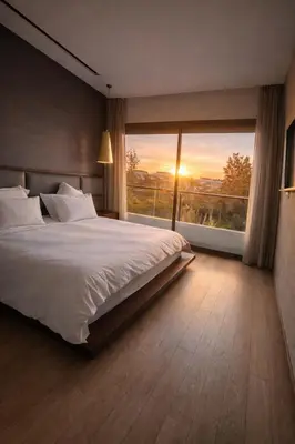 a bedroom with a large bed and a large window at Luxury Stay in Prestigia Golf City in Bouskoura
