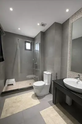 a bathroom with a toilet and a sink and a shower at Luxury Stay in Prestigia Golf City in Bouskoura