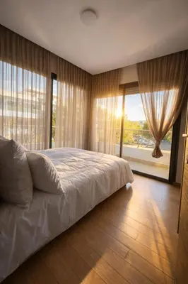 a bedroom with a large bed and a large window at Luxury Stay in Prestigia Golf City in Bouskoura