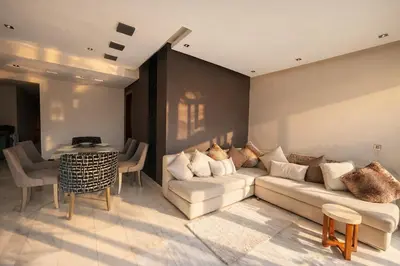 a living room with a couch and a table at Luxury Stay in Prestigia Golf City in Bouskoura