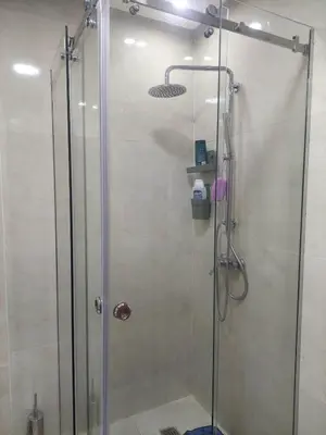 a shower with a glass door in a bathroom at Appartement neuf avec piscine, balcon et à deux pas de la mer