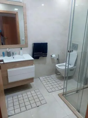 a bathroom with a toilet and a sink and a shower at Appartement neuf avec piscine, balcon et à deux pas de la mer