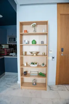 a wooden shelf in a room with a kitchen at Cedar Stays Studio apartment 1chambre salon - WiFi - climatisation - parking - machine a laver- 5 min CFC in Casablanca