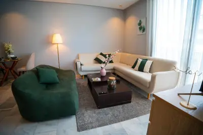 a living room with a couch and a table at Cedar Stays Studio apartment 1chambre salon - WiFi - climatisation - parking - machine a laver- 5 min CFC in Casablanca