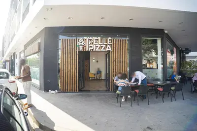 a couple of people sitting at a table outside a restaurant at Cedar Stays Studio apartment 1chambre salon - WiFi - climatisation - parking - machine a laver- 5 min CFC in Casablanca