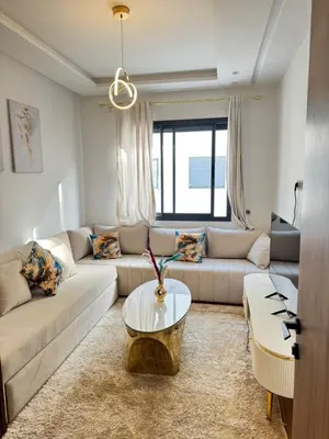 a living room with a couch and a table at Appartement de luxe in Casablanca