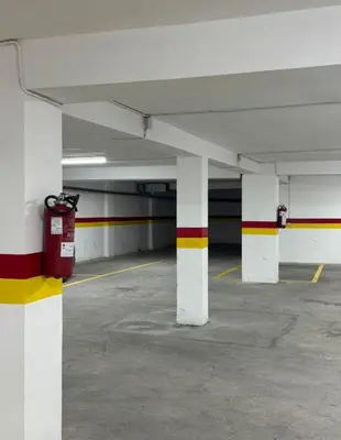 an empty parking garage with white columns and a fire hydrant at Appartement de luxe in Casablanca
