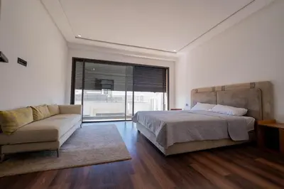a bedroom with a bed and a couch and a window at Jack Beach Bay in Tamaris