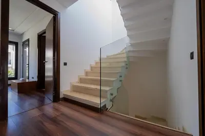 a staircase in a house with a glass wall at Jack Beach Bay in Tamaris