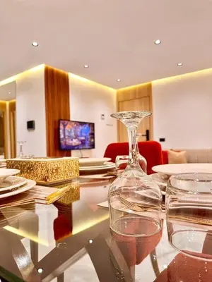a glass table with wine glasses and plates on it at Modern studio in Casablanca in Casablanca