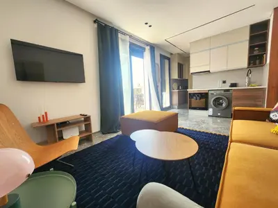 a living room with a couch and a table at The 28 Triangle d'Or by IB Signature - Stylish two-Bedroom flat - Wifi, Self Check-in, Day and Night Security, Terrace, Swimming pool, free parking close to all amenities in Casablanca