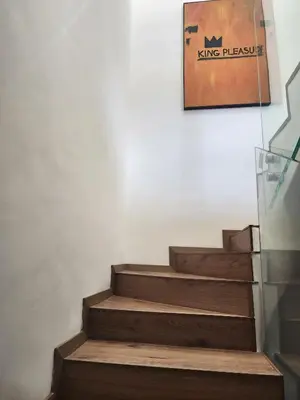 a set of stairs with a painting on the wall at The 28 Triangle d'Or by IB Signature - Stylish two-Bedroom flat - Wifi, Self Check-in, Day and Night Security, Terrace, Swimming pool, free parking close to all amenities in Casablanca