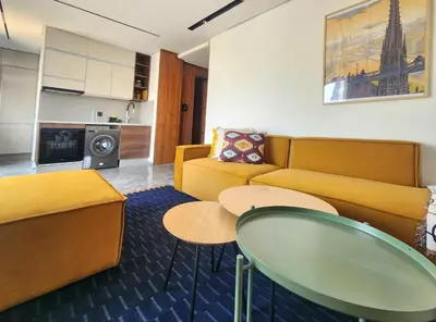 a living room with a couch and a table at The 28 Triangle d'Or by IB Signature - Stylish two-Bedroom flat - Wifi, Self Check-in, Day and Night Security, Terrace, Swimming pool, free parking close to all amenities in Casablanca