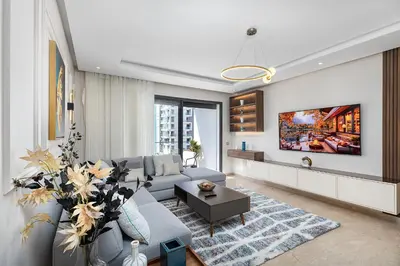 a living room with a couch and a tv at Luxury Apartment Perles d'Agdal, Facing Agdal Station in Rabat