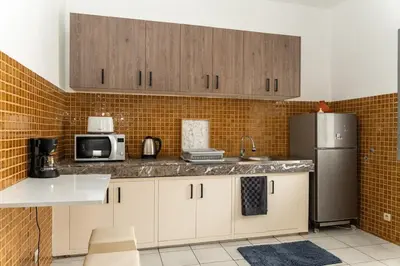 a kitchen with a refrigerator and a microwave at Spacious and colorful apartment close to MahajRiad in Rabat