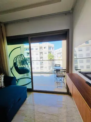 a living room with a large sliding glass door with a balcony at BenHost Appartement Casablanca Maarif in Casablanca