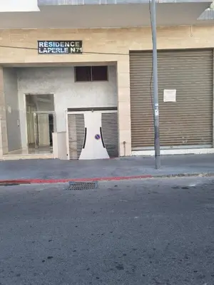 a building with a door on the side of a street at BenHost Appartement Casablanca Maarif in Casablanca