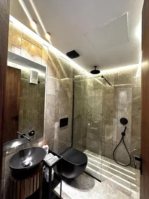 a bathroom with a sink and a shower with a toilet at New luxury central apartment in Casablanca