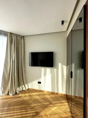 a living room with a flat screen tv on a wall at New luxury central apartment in Casablanca