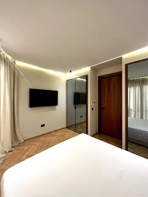 a bedroom with a bed and a television on the wall at New luxury central apartment in Casablanca