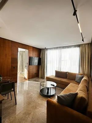 a living room with a couch and a table at New luxury central apartment in Casablanca