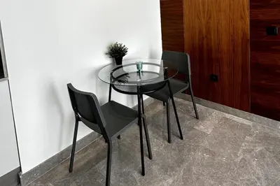 a glass table with two chairs and a plant on it at New luxury central apartment in Casablanca