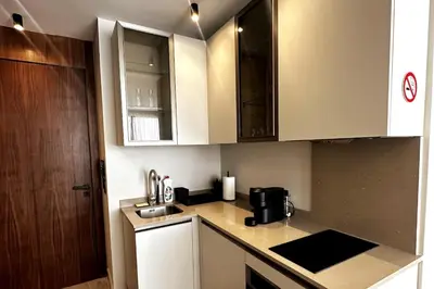 a kitchen with white cabinets and a counter top at New luxury central apartment in Casablanca