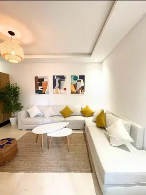 a living room with a white couch and a table at Apartment with large terrace Mohammedia in Mohammedia