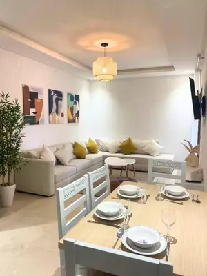 a living room with a table and a couch at Apartment with large terrace Mohammedia in Mohammedia