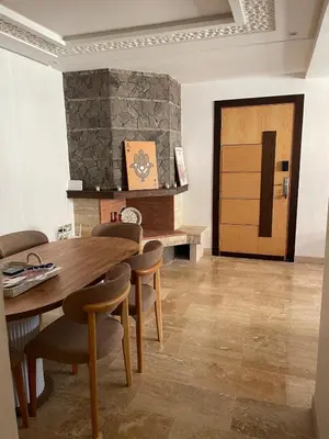 a dining room with a wooden table and chairs at Luxury Beach Front Cherrat Plage Apartment in Sidi el Haj Bou Derbala
