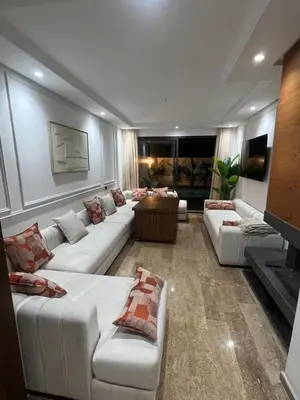 a large living room with white couches and a fireplace at Apartement avec piscine privée Casablanca in Casablanca