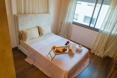 a bedroom with a bed with a tray of food on it at VIVASTAY Casablanca - Urban Nest 3 Bedrooms High Standing Les Princesses in Casablanca