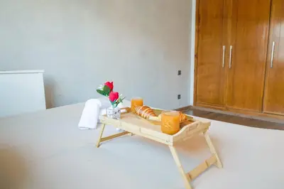 a table with bread and flowers on it in a room at VIVASTAY Casablanca - Urban Nest 3 Bedrooms High Standing Les Princesses in Casablanca