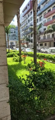 a park with palm trees and flowers in front of a building at VIVASTAY Casablanca - Urban Nest 3 Bedrooms High Standing Les Princesses in Casablanca