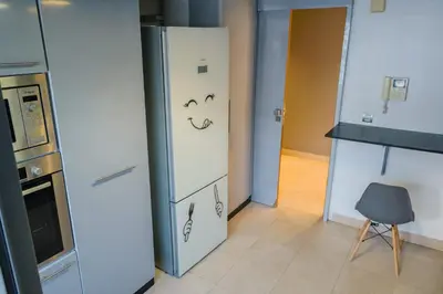 a kitchen with a refrigerator with a face drawn on it at VIVASTAY Casablanca - Urban Nest 3 Bedrooms High Standing Les Princesses in Casablanca