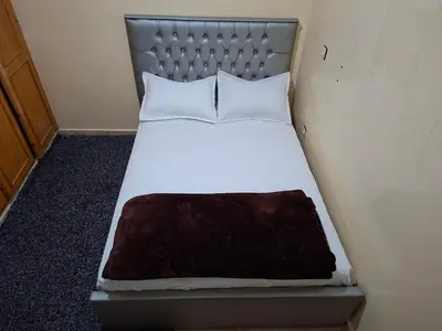 a bed in a small room with a silver headboard at Stay in Rabat with local in Rabat