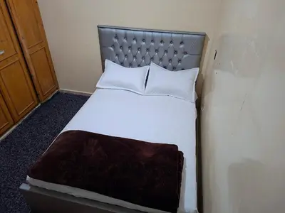 a bedroom with a bed with a metal headboard at Stay in Rabat with local in Rabat