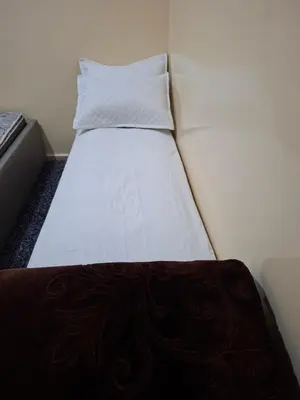 a small bed in a small room with a pillow at Stay in Rabat with local in Rabat