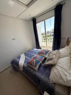 a bed in a room with a window at Cozy Dream Land Appartement 1 bed room Sea View, Sidi Rahal Beach in Sidi Rahal