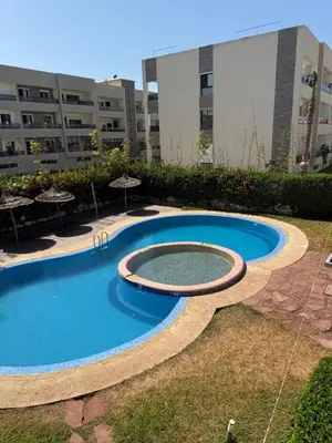 a large swimming pool in front of a building at Cozy Dream Land Appartement 1 bed room Sea View, Sidi Rahal Beach in Sidi Rahal