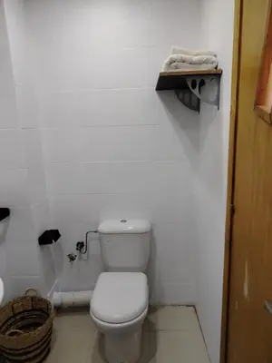 a white bathroom with a toilet and a basket at Cozy Dream Land Appartement 1 bed room Sea View, Sidi Rahal Beach in Sidi Rahal