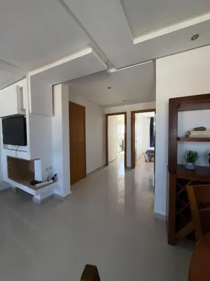 a living room with white walls and a flat screen tv at Cozy Dream Land Appartement 1 bed room Sea View, Sidi Rahal Beach in Sidi Rahal