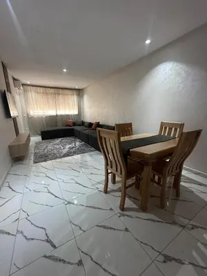 a living room with a table and chairs and a couch at Calm studio in Casablanca