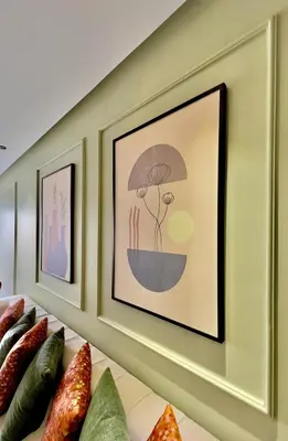 a row of framed pictures on a wall with vegetables at Logement cosy avec terrasse in Casablanca