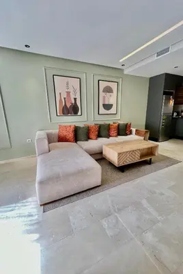a living room with a couch and a coffee table at Logement cosy avec terrasse in Casablanca