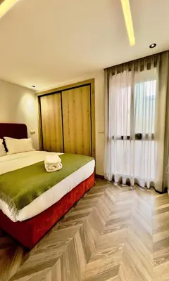 a bedroom with a bed and a large window at Logement cosy avec terrasse in Casablanca