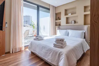 a bedroom with a white bed with towels on it at Résidence Dunkerque - Duplex in Casablanca