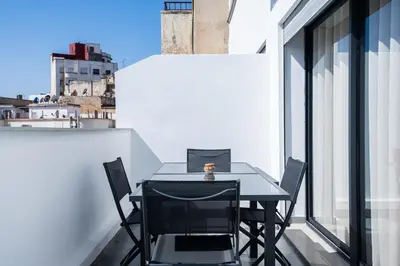 a table and chairs on the balcony of a building at Résidence Dunkerque - Duplex in Casablanca
