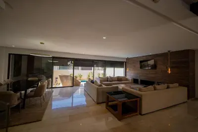 a living room with couches and a dining room at Villa vue océan Jack Beach Bay in Tamaris