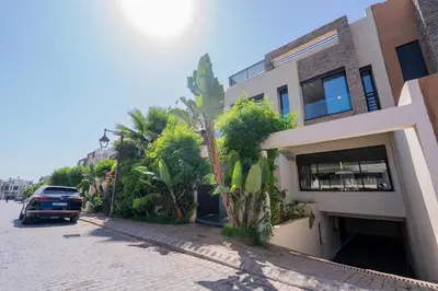 a car parked next to a building on a street at Villa vue océan Jack Beach Bay in Tamaris